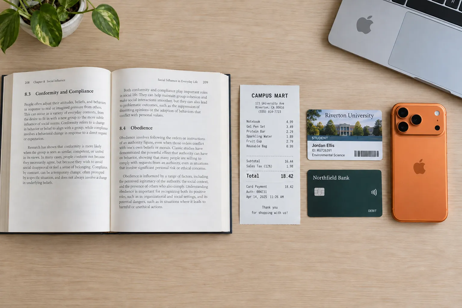 Seen from above: an open textbook with printed text, a silver laptop corner, a crisp receipt from CAMPUS MART totalling 18.42, a student ID card with a fictional university name and an iPhone 17 Pro in cosmic orange.